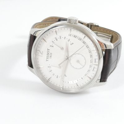 a close up of a watch on a white surface