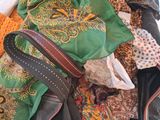 un tas de vêtements et un sac à main posés par terre