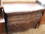a dresser with a mirror on top of it in a room