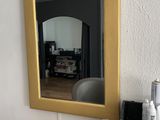 a mirror on the wall above a desk with a hair dryer and a hair dryer
