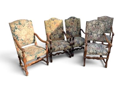 four chairs with floral upholstered cushions and a wooden frame