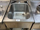 a sink that is in the middle of a kitchen
