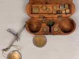 a small wooden box with coins in it and a pair of scissors