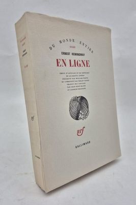 an old book sitting on top of a white table next to a white wall