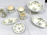 a table that has a bunch of dishes and cups on it
