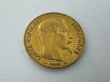 a close up of a gold coin on a white surface