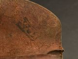 a close up of a brown leather hat with a black background