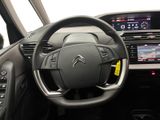 the interior of a car with a steering wheel and dashboard controls