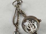 an image of a close up of a keychain with a clock on it