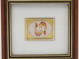 painting of a cat in a frame on a white wall