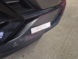 a close up of a car ' s bumper with a sticker on it