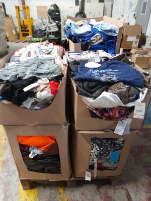 two boxes of clothes sitting on top of each other in a warehouse
