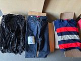 a lot of clothes that are sitting on a cardboard box