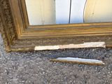 a picture of a broken mirror and a piece of wood on the ground