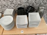 a lot of plates and bowls on the table