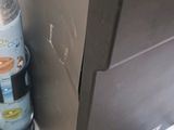 a bottle of water sitting next to a refrigerator