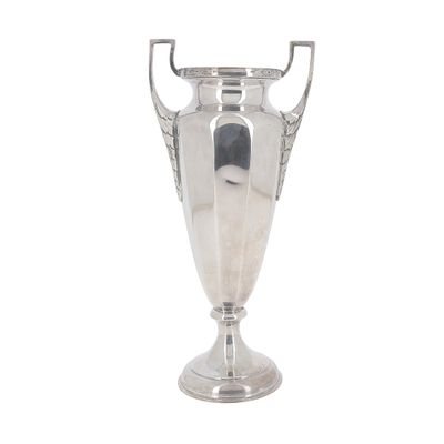 a silver trophy that is sitting on a white surface