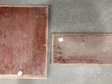 two pieces of wood on the floor next to each other