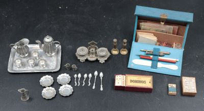 a box of silverware on a table next to other items