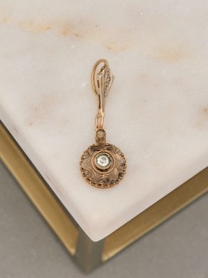 an image of a gold plated pendant with a green stone