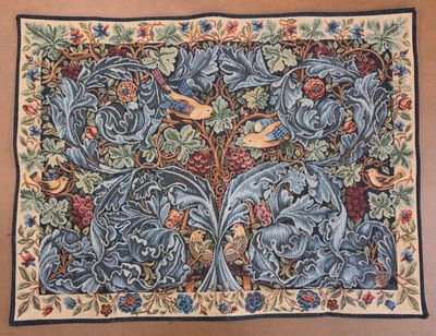 a tapestry with birds and flowers on a brown background