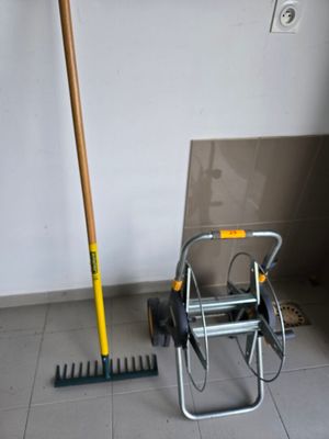 a broom and a rake on the floor in a room