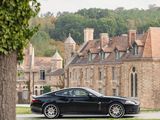 a black sports car parked in front of a large building