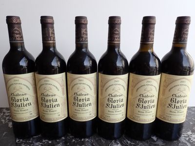 six bottles of wine are lined up in a row on a table