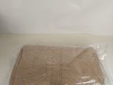 a plastic bag with a piece of brown paper in it