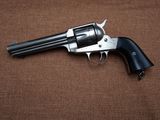 a close up of a revolver on a brown background