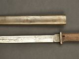 two knives are sitting side by side on a table