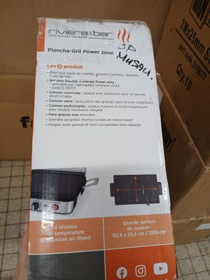 packaging of a black and white stove top oven sitting on top of a cardboard box
