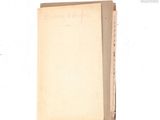 an old book with writing on it sitting on a table