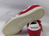 a close up of a pair of red and white sneakers