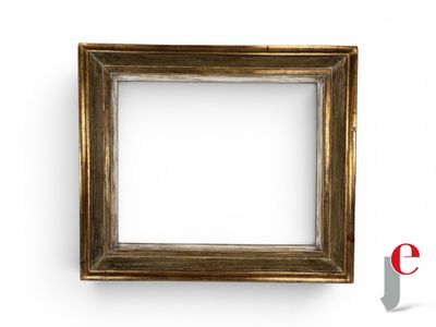 an empty picture frame on a white wall with a red e logo in the background