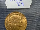 a close up of a gold coin with a note on it