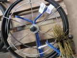 a wheel with a blue spoke and a brush next to it
