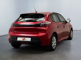 the rear end of a red car in a white room