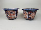pair of blue and orange bowls with floral designs on them