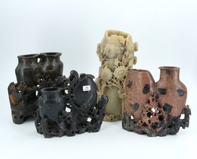 four different vases are sitting next to each other on a white surface