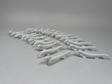 a lot of white plastic hand tools on a white surface
