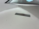 a sticker on the hood of a white car