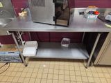 a microwave sitting on top of a stainless steel table