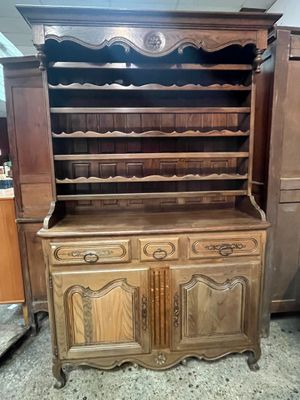 an image of a wooden cabinet with many shelves and drawers