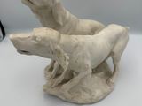 two white dogs that are sitting on a table
