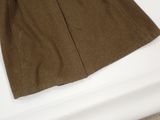 brown skirt sitting on a white table with a white table cloth