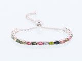 a bracelet with multi colored stones on a white background