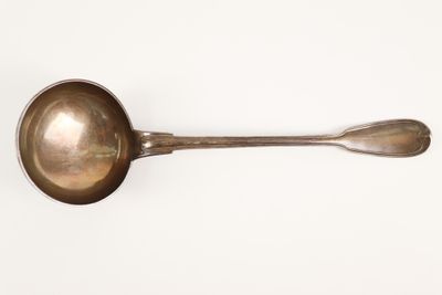 a spoon and a spoon rest on a white surface