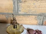 a small lamp that is on a table next to some thread