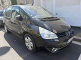 a small black car parked on the side of the street